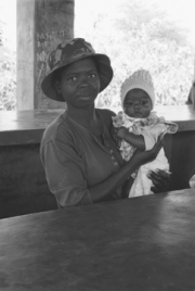 African Woman Holding Baby at Store