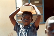 Zimbabwe - Boy Carrying Box on his Head