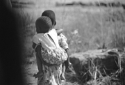 Zimbabwe - Girl with Baby Walking Away
